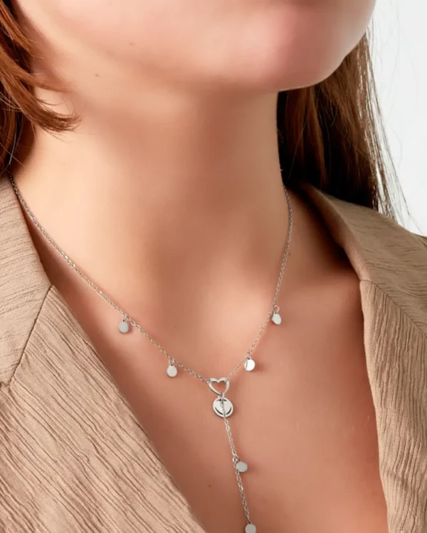 Woman wearing silver heart charm drop necklace | waterproof stainless steel jewelry from Cutu Store Malta