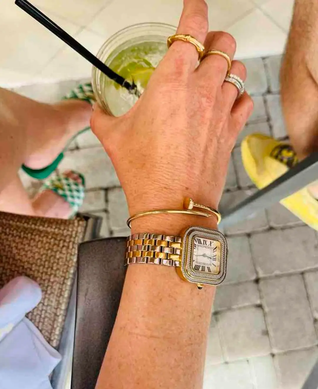 Women's GV2 Bellagio two-tone diamond watch worn on wrist with bracelet stack