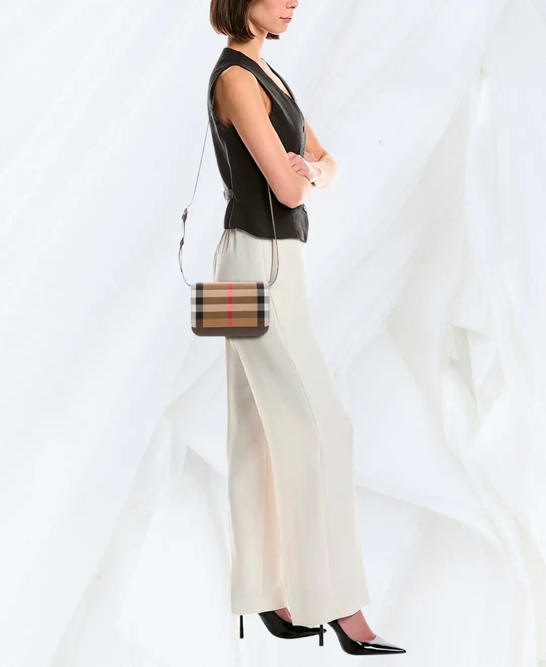 Model wearing Burberry Madison check crossbody bag