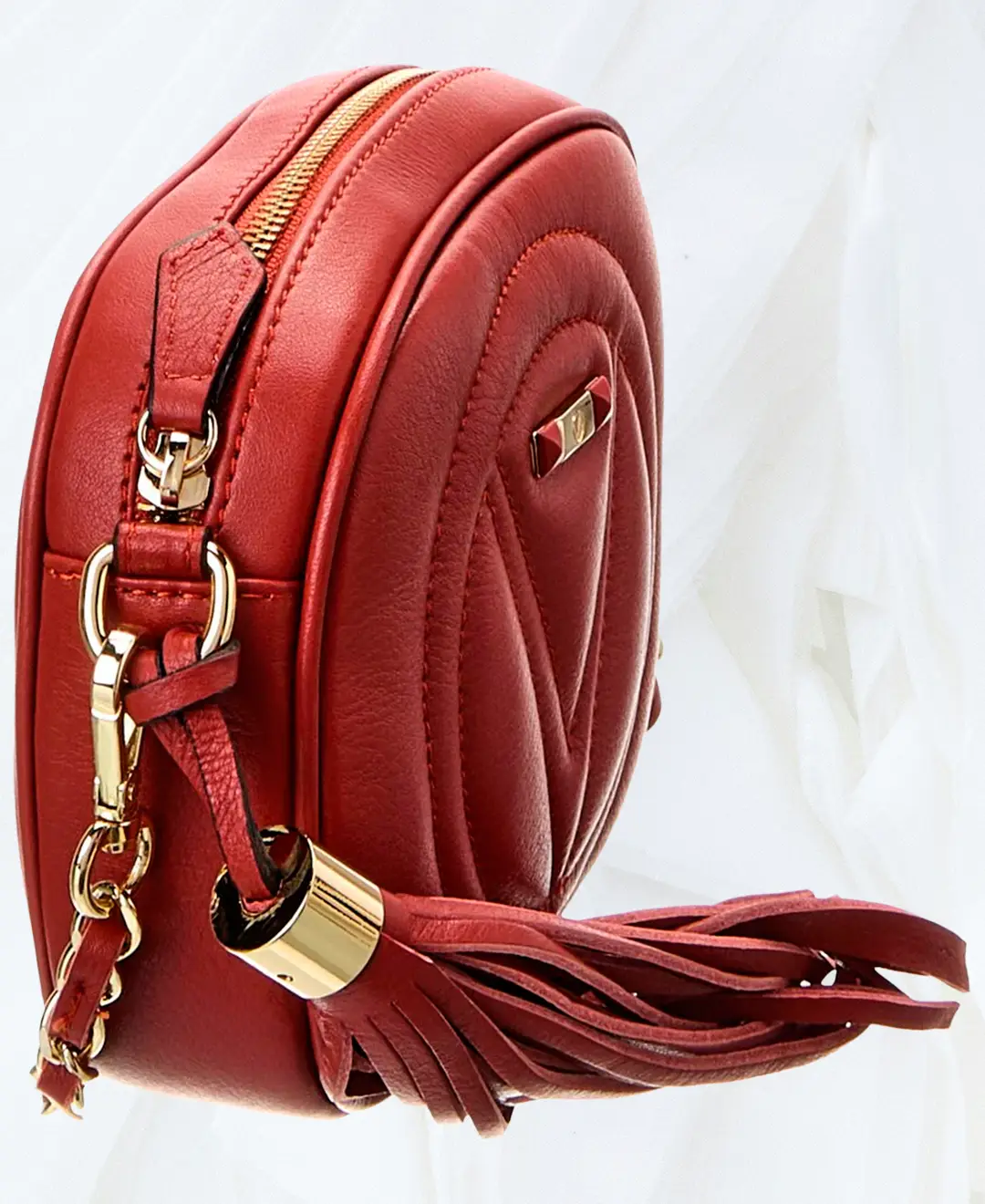 Side angle of Valentino Nina Signature red leather bag with tassel