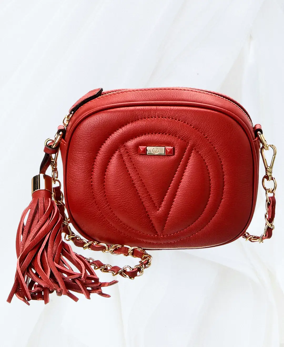 Angled front view of Valentino Nina Signature red crossbody bag