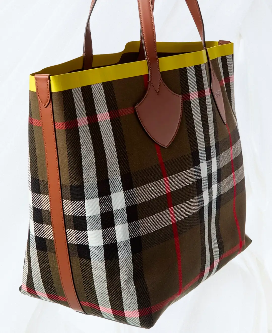 Angled side view of Burberry Large Reversible Check Canvas & Leather Tote