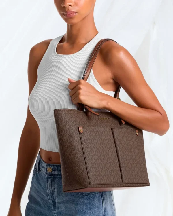 Michael Kors Jet Set Medium Logo Pocket Tote in brown worn on shoulder
