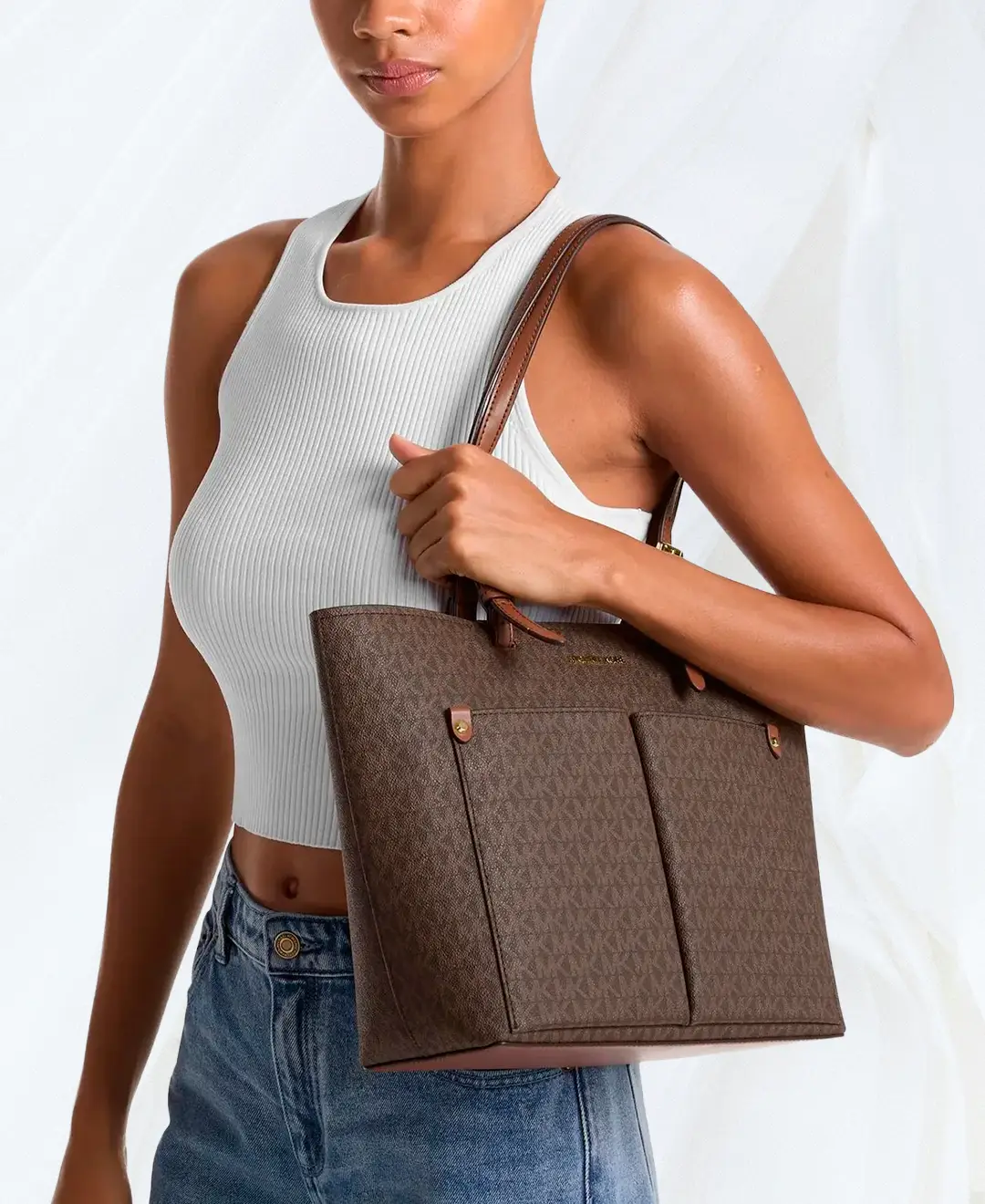 Michael Kors Jet Set Medium Logo Pocket Tote in brown worn on shoulder