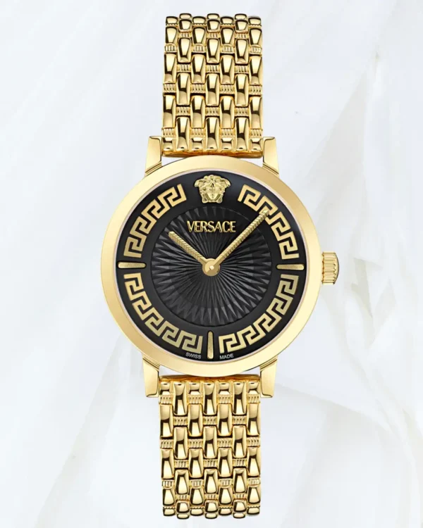 Close front view of Versace Greca Fortuna black dial watch with gold bracelet